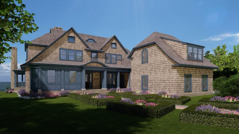 A large, two-story house with a shingled exterior and gabled roof is surrounded by lush gardens. The house features a prominent porch with blue columns and trim. Bright sunlight illuminates the manicured lawn and flowerbeds, with trees framing the scene against a clear blue sky.