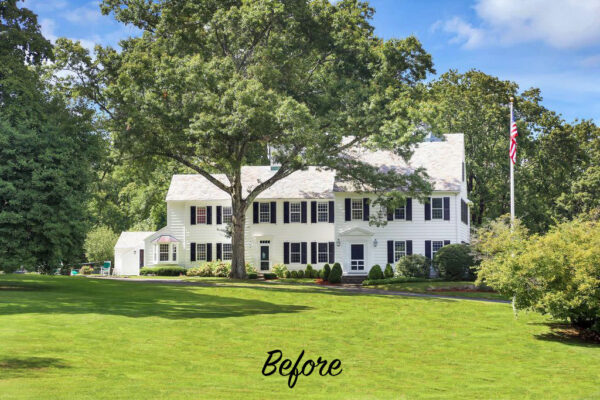 A large white colonial-style house with black shutters and a gabled roof resides behind a sprawling green lawn. A flagpole with an American flag stands to the right. Mature trees surround the property, and the word Before is written in script at the bottom.