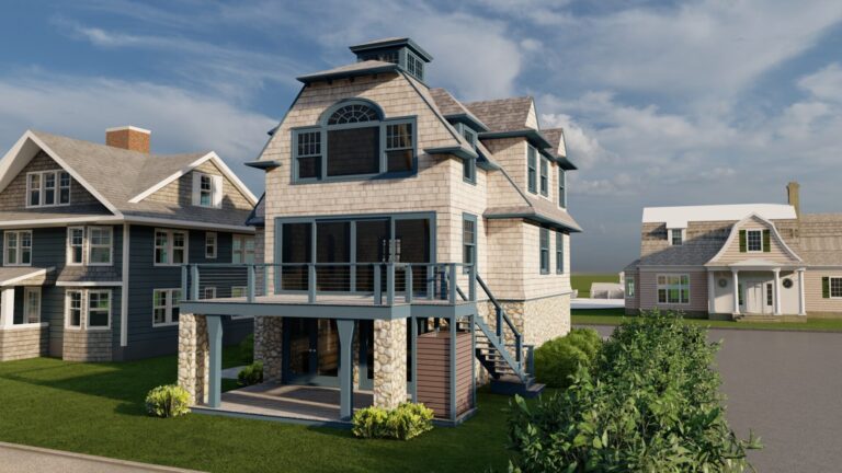 A two-story house with a gray shingle exterior, large upper deck with cable railing, and stone pillars below. It has a gambrel roof, large windows, and stairs leading to the deck. The house is on a grassy lot with shrubs, surrounded by similar homes under a blue sky.
